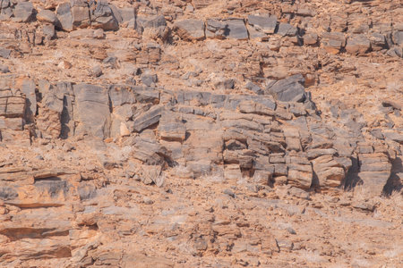 The Namibian desert is home to scattered grey stones and rugged rock formations shaped by natural processes over millennia.の写真素材