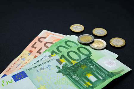 Abstract and conceptual of banknotes and money, in euros, close up on black background. Business and...