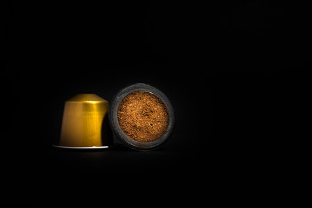 Abstract and conceptual of home coffee capsule machines. Collection of espresso coffee capsules isolated on black background, close-up view with details. Graphic resources with copy space.の写真素材