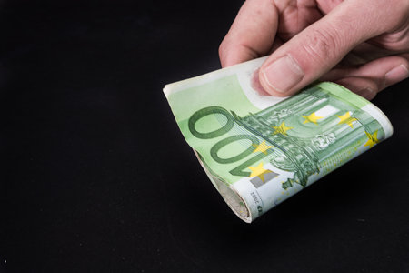 Abstract and conceptual of banknotes and money, in euros, close up on black background. Business and financial concept, isolated on desk.の写真素材