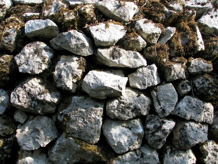 Old wall built with a gray stone
