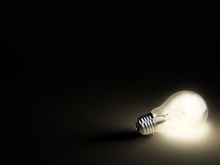 Turned on electric light bulb on black backgroundの写真素材