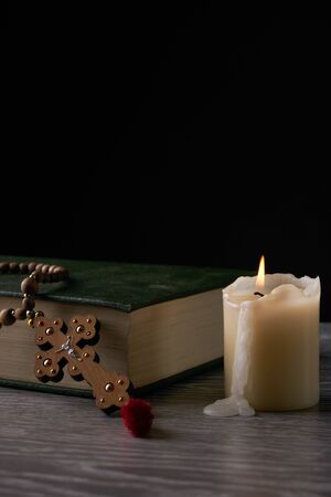 Wood cross, holy bible and candle on wooden table. Religion conceptの写真素材