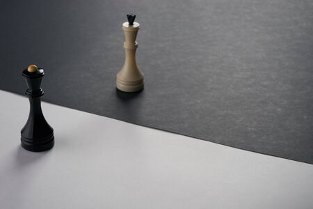 King and Queen Chess Pieces on black and white surfaceの写真素材