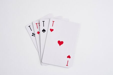 A winning poker hand of four aces playing cards suits on whiteの写真素材