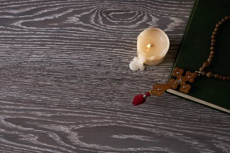 Wood cross, holy bible and candle on wooden table. Religion concept with copy space. Top viewの写真素材