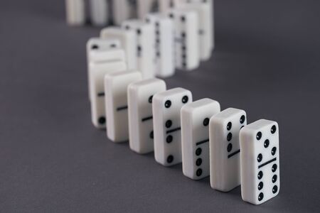 White domino play pieces on blue backgroundの写真素材