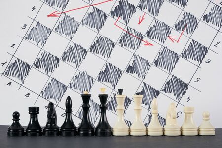 Set of black and white chess in classic design and strategy board on backgroundの写真素材