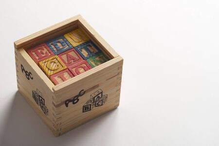 Education word on wooden cubes with letters in wooden boxの写真素材