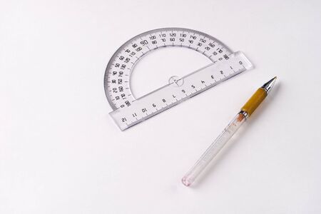 Pen and protractor on white backgroundの写真素材