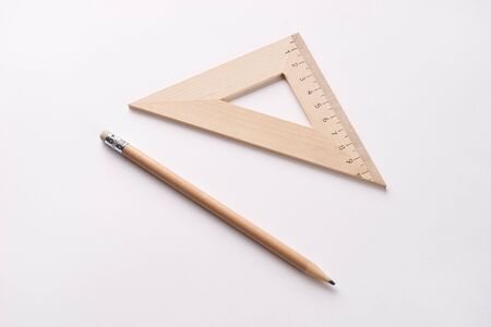 Pencil and triangle ruler on white backgroundの写真素材