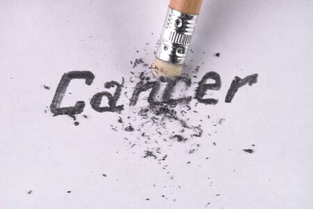 Cancer word removing with pencil eraser. Healthcare and medicine conceptの写真素材