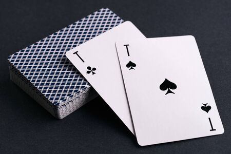 Close up of playing cards deck with two aces on dark backgroundの写真素材