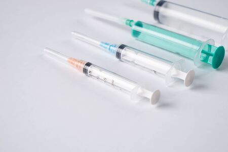 Syringes of different size on white background. Medicine plastic vaccination equipment