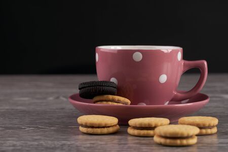 Tea cup and cookies on wooden tableの写真素材