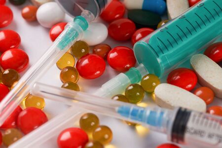 Syringes and different colored medicine and types of pills. Medical health or drugs conceptの写真素材