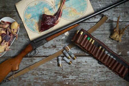 Hunting equipment in a forester lodge.Old wooden background.Top view