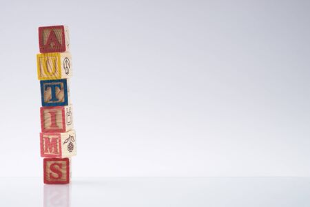 concept of autism word on wooden cubes against white background. Copy spaceの写真素材