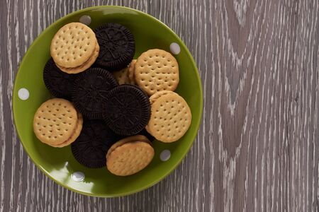 Chip cookies , biscuits in plate on rustic wood background, top viewの写真素材