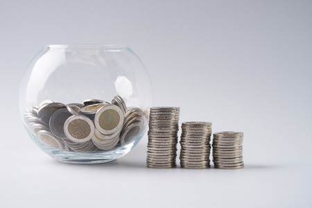 Saving Money, Financial, Business Growth concept, coins stack and piggy bank with coins on isolated white background.の写真素材