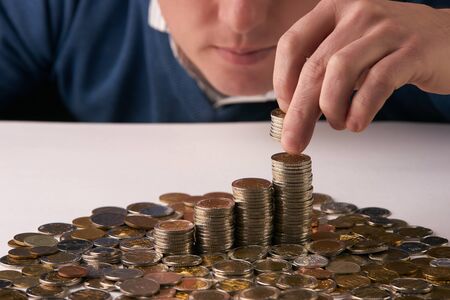 Man putting coins on stack with holding money, Concept business, finance, money saving