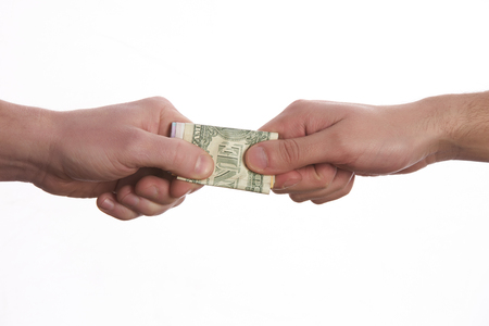 Giving a bribe. Money in hand.Concept - corruption.Isolated on White background.の写真素材