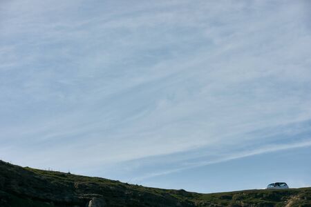 Beautiful landscape of blue spring cloudy sky with green hills