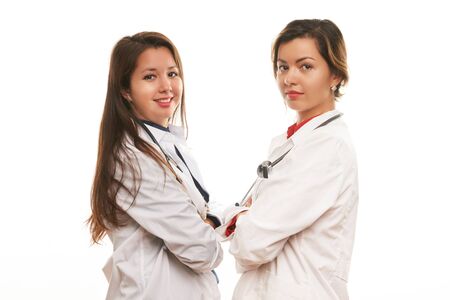 Portrait of two successful female doctor and nurse in medical uniform and stethoscope isolated on white background. Close-up portrait. World Medicine Day and healthcare conceptの写真素材