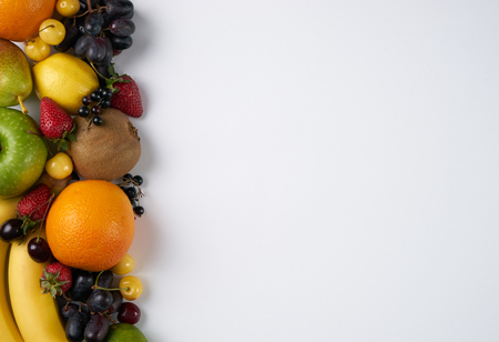 Top view of a huge group of fresh vegetables and fruit on white background with copy space. Vegetables VS Fruit - High quality studio shotの写真素材