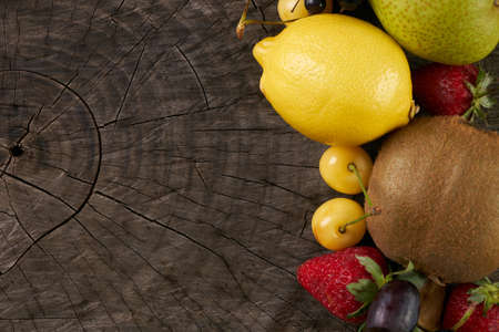 Collection fruits and vegetables isolated on wooden background with copy space. Detox and healthy food concept. Vegetarian food.の写真素材