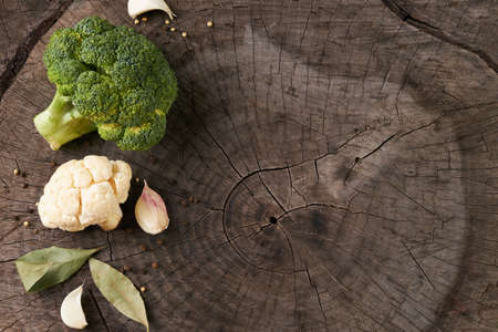 Assortment of cabbages broccoli and cauliflower on old wooden background with copy space.  Helathy vegetarian food and detox concept.の写真素材