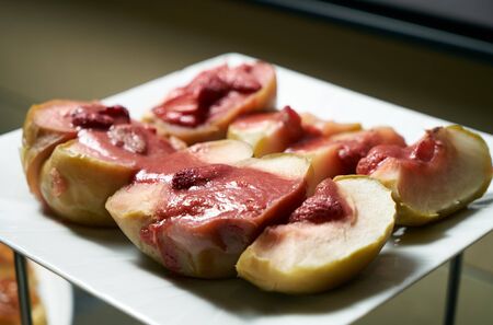 Baked apples with honey and Strawberry on white plate. Sweet warm dessert. Healthy eatingの写真素材