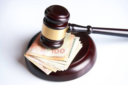 Law gavel, judge mallet or auctioneer's hammer and money stack isolated on white background with copy space, Corruption and financial crime theme. Concept of auction, close-upの写真素材