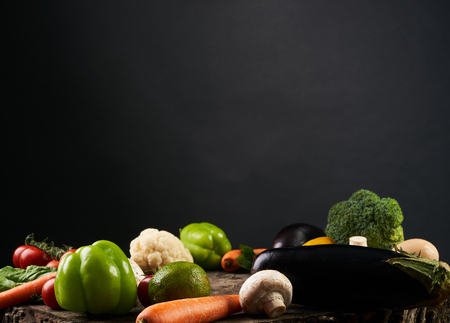 Variety of  vegetables, on the wooden table isolated on black background, top view, copy space, selective focus.の写真素材