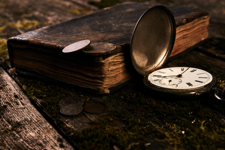 Pocket watch with an old antique bible book and ancient copper cの写真素材