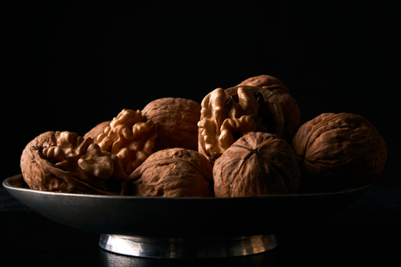 Walnuts on black background