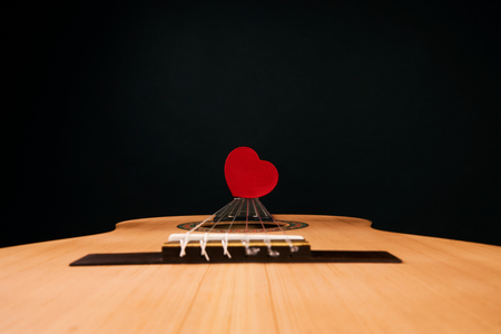 Valentines Day concept with red hearts on acoustic guitar isolated on black background with copy space for textの写真素材