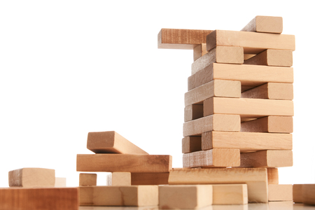 Blocks of wood isolated on white background with copy space. Wooden blocks tower, strategy game as a business plan for team workの写真素材