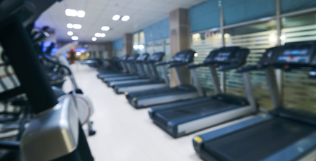 Blurry perspective view gym facility service room. Blur abstract background modern fitness center...