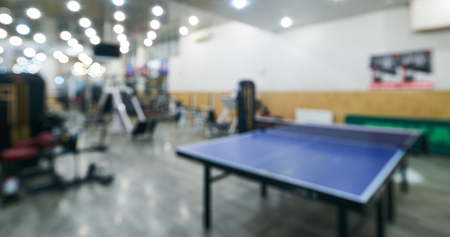 Blur abstract background modern gym center with fitness equipment and ping-pong tableの写真素材