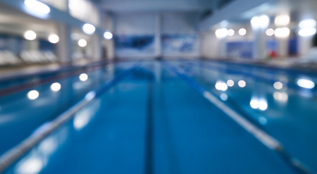 Indoor swimming pool in blur background. Abstract blurry swimming pool in fitness centreの写真素材