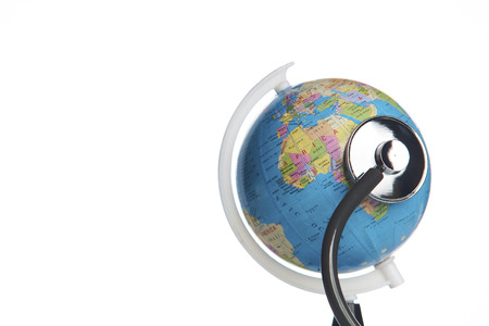 Green earth day, save the wold and global healthcare concept. Medical stethoscope wrapped around...