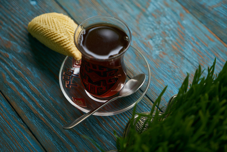 Shekerbura with nuts and honey. Novruz tray with Azerbaijan national pastry and glass of black tea on wooden table background, top view. Delicious dessert holiday food shekerburaの写真素材