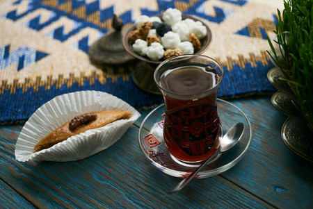Pakhlava or baklava with nuts and honey. Novruz tray with Azerbaijan national pastry and drinking...