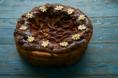 Traditional Ukrainian wedding bread korovai or karavai with decorations on rustic wooden table...