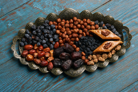 Traditional pakhlava baklava pastry on novruz tray with dry fruits snack. Azerbaijan national Novruz eastern new year spring celebration conceptの写真素材