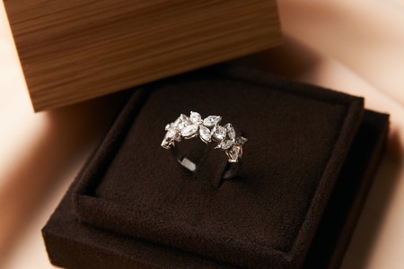 Diamond ring in dark jewel box. Close-up of a jewelry box with elegant gold ring with brilliants,...