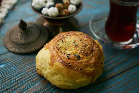 Novruz holiday with Azerbaijan national pastry Gogal and glass of black tea with traditional snack...