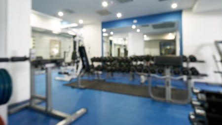 Abstract blurred of fitness gym interior with exercise equipment, background for banner presentation.の写真素材