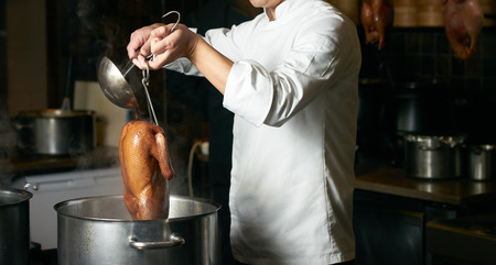 Chef preparing of Peking Roast Duck in the kitchen of restaurant. Peking Duck is a famous duck dish from Beijingの写真素材